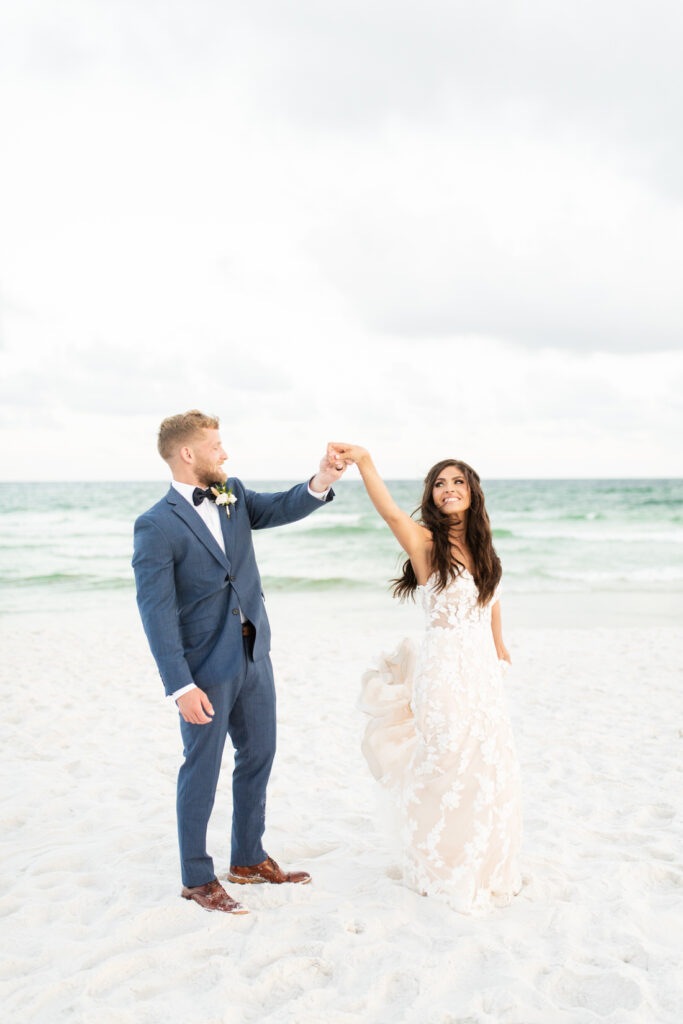 bride and groom dancing on beach