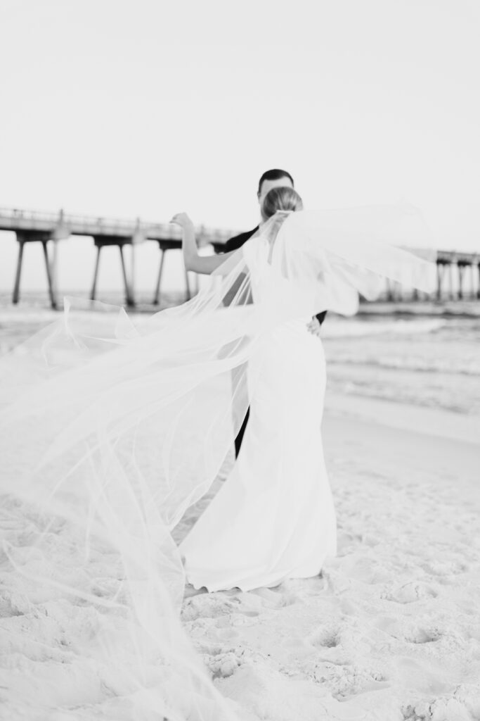 pier suite wedding pensacola beach venue golden hour bride groom black and white