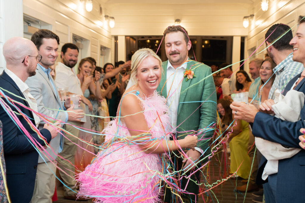 bud and alleys reception pink feather dress ribbon exit